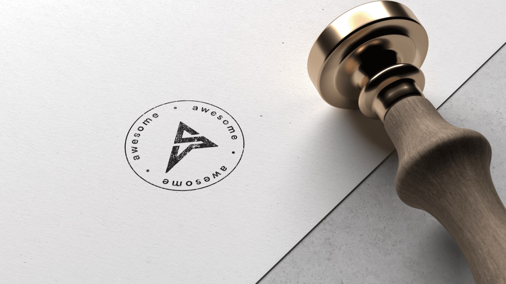 A brass stamp beside the inked Awesome seal on white paper