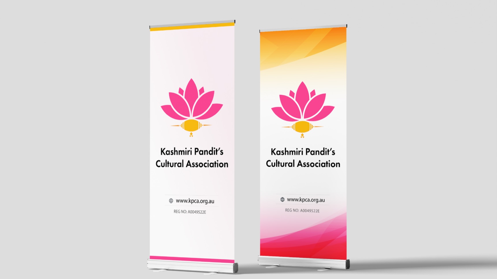 Two KPCA roll-up banners, one white and one with a saffron-to-pink gradient, with the website and registration number
