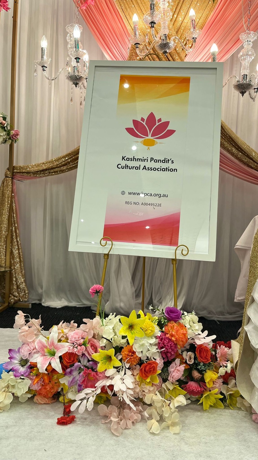 The KPCA welcome sign on an easel at the event, surrounded by flowers