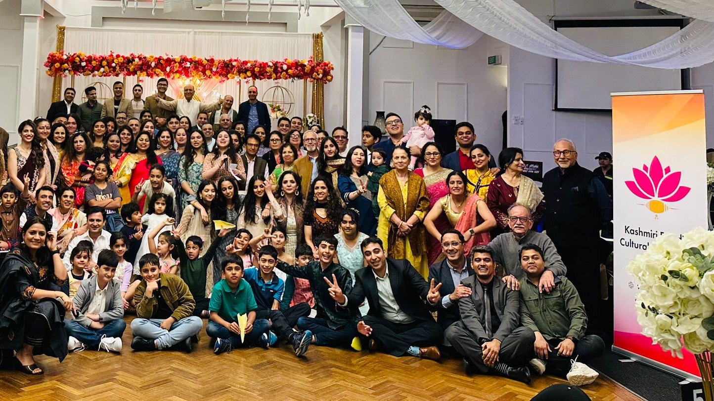 A large group photo of the KPCA community at the launch event, with a KPCA roll-up banner on the right