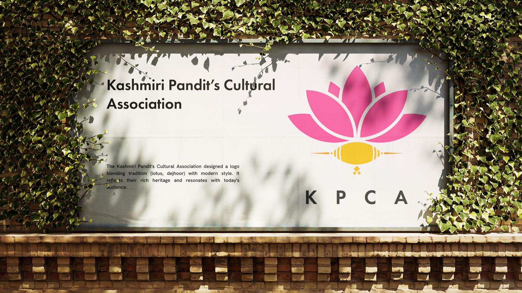 KPCA sign on an ivy-covered brick wall with the full name, a short description and the pink and marigold mark